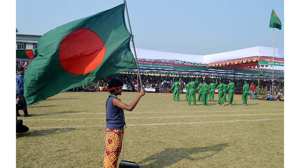 Chapainawabganj students perform to celebrate the 46th Victory Day on Friday. Photo: Focus Bangla
