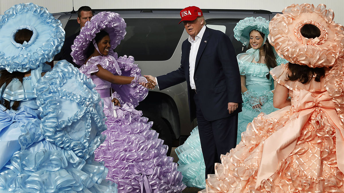 U.S. President-elect Donald Trump greets a group of gathered Azalea Trail Maids as he arrives for stop on his USA Thank You Tour event in Mobile, Alabama, U.S., December 17, 2016. Reuters