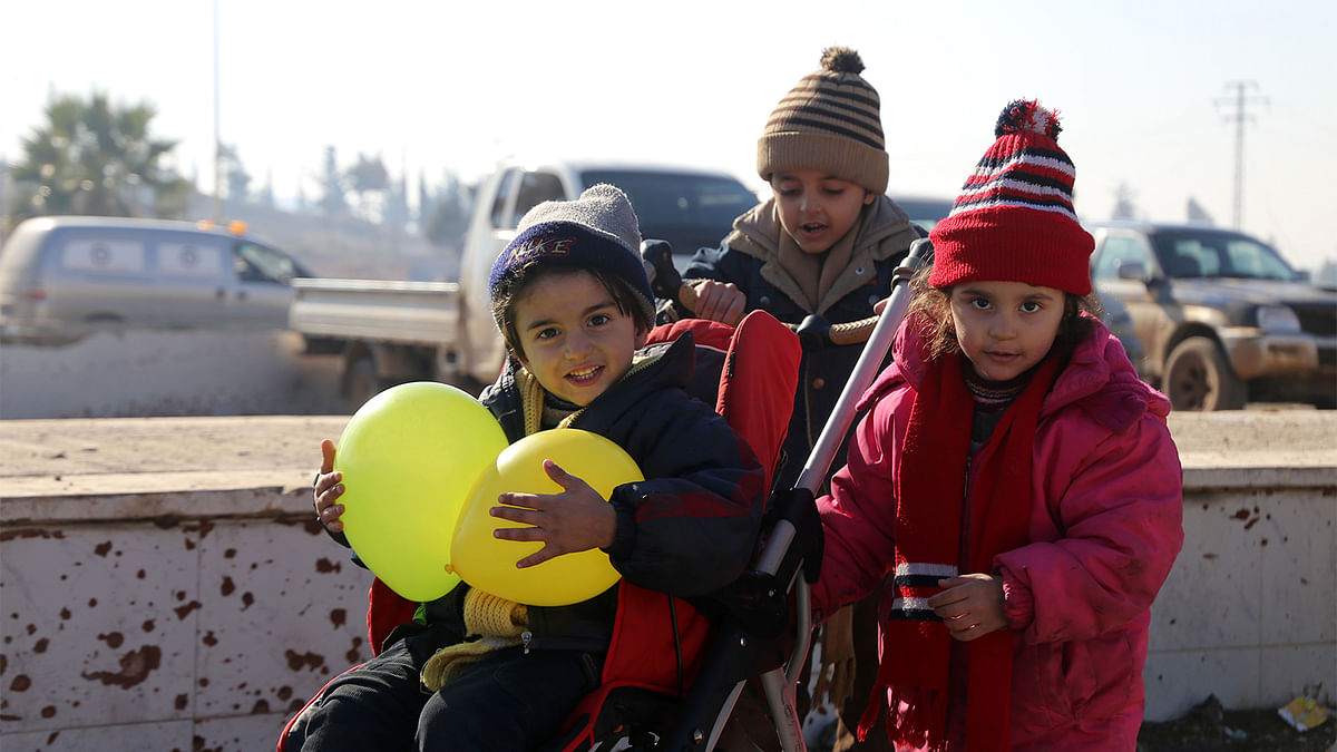 Syrians, who were evacuated from the last rebel-held pockets of Syria`s northen city of Aleppo, arrive in the opposition-controlled Khan al-Assal region, west of the embattled city. Photo: AFP