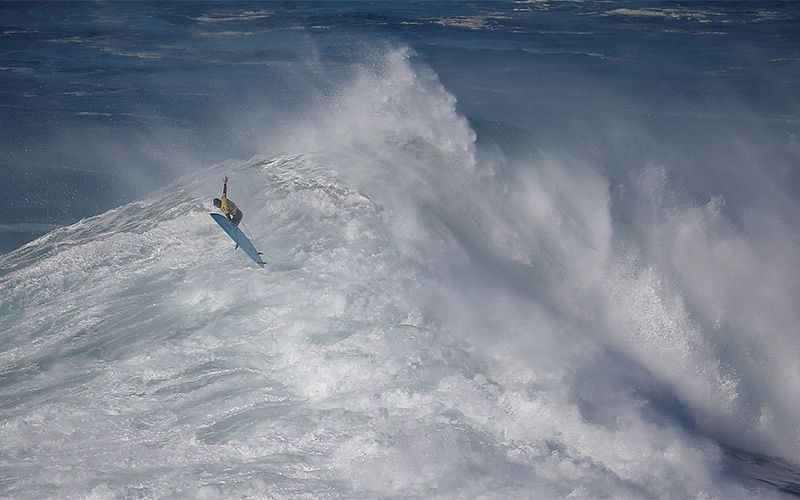 South African surfer Grant Baker drops in on a large wave during the Nazare Challenge championship at Praia do Norte in Nazare, Portugal December 20, 2016. Photo: Reuters