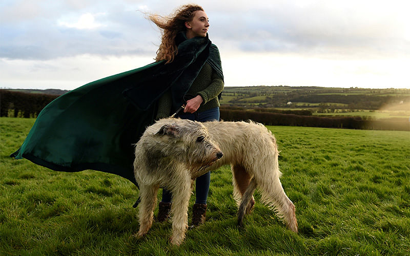 Rebecca Smith poses for a photograph during winter solstice with her Irish Wolfhound dog called Amazing Grace at the 5000 year old stone age tomb of Newgrange (not in view) in the Boyne Valley at sunrise in Newgrange, Ireland, December 21, 2016. Photo: Reuters