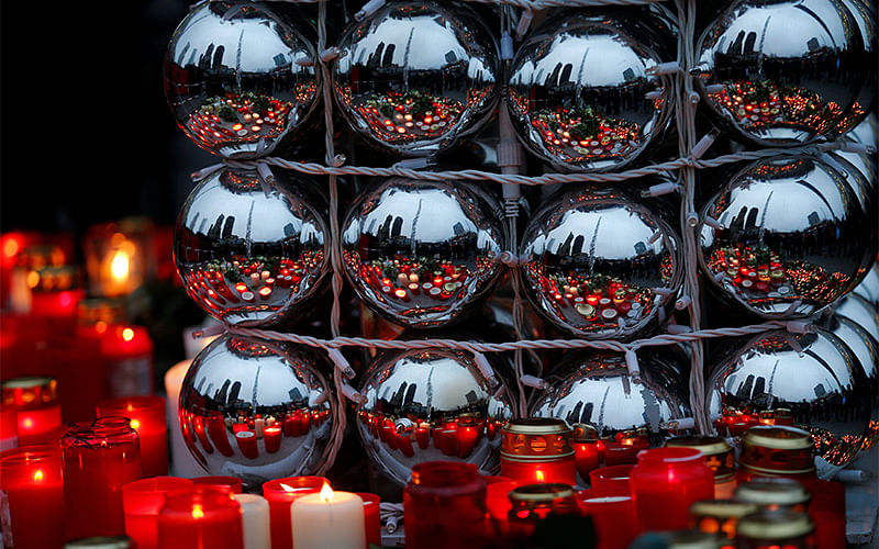 Candles are refected in Christmas tree balls at the Christmas market in Berlin, Germany, December 20, 2016, one day after a truck ploughed into a crowded Christmas market in the German capital. Photo: Reuters