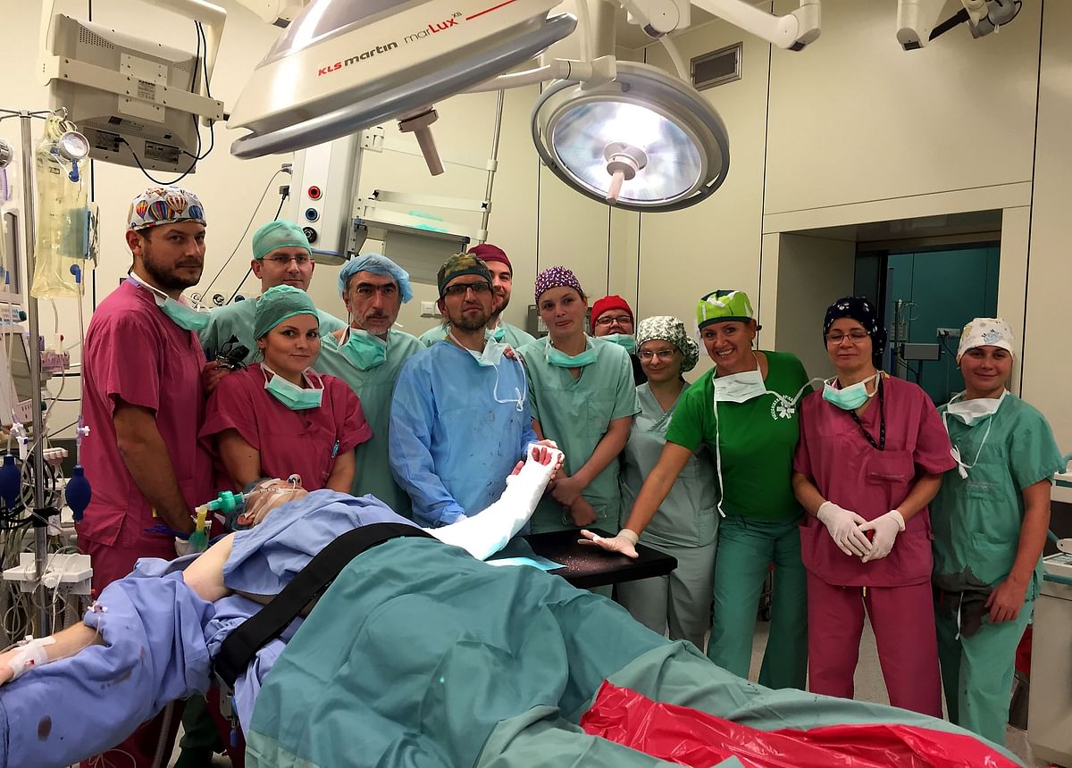 This handout picture released by University of Wroclaw on December 22, 2016 shows surgeons at Wroclaw Medical University Hospital posing after they had successfully attached a hand from a deceased donor to a man born without one. Photo: AFP