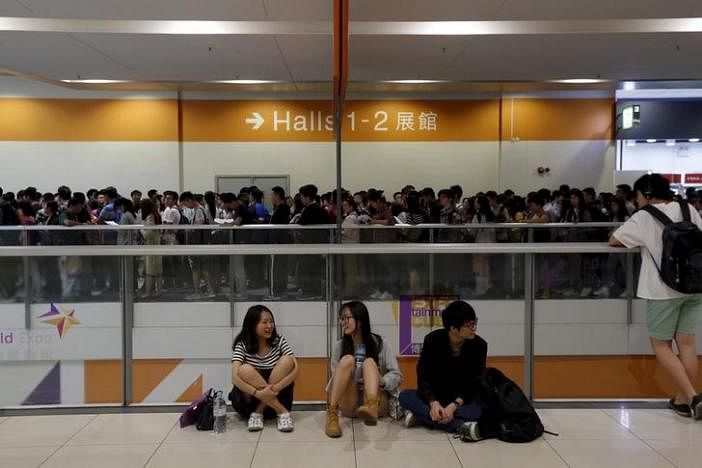 Students chat as others line up to take part in SAT examinations at Asia-World Expo near Hong Kong Airport in Hong Kong, China 3 October, 2015. REUTERS