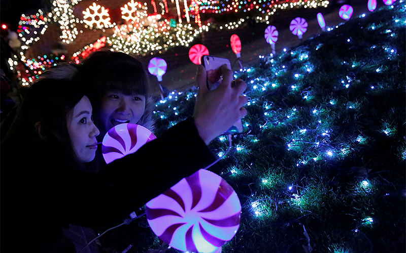 Women pose for a selfie at the Dyker Heights Christmas Lights in the Dyker Heights neighborhood of Brooklyn, New York City, US. Photo: Reuters