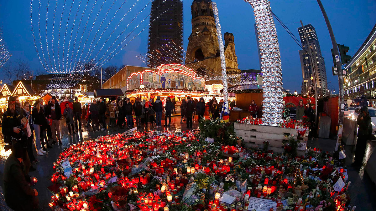 Flowers and candles are placed near the Christmas market at Breitscheid square in Berlin, Germany. Photo: Reuters