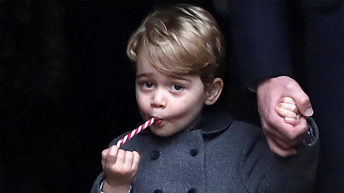 Prince George, the son of the Duke and Duchess of Cambridge, sucks a sweet as he leaves following the morning Christmas Day service at St Mark`s Church in Englefield, near Bucklebury in southern England, Britain, December 25, 2016. Photo: Reuters