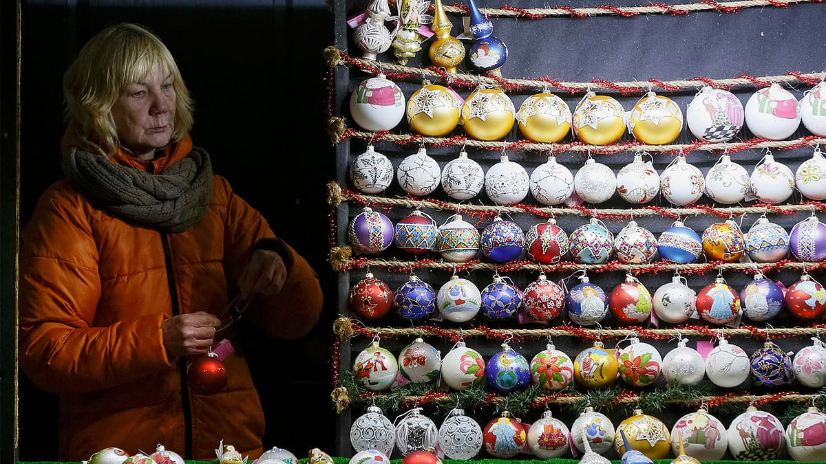 A vendor of festive decorations marking the New Year and Christmas season, works in central Kiev, Ukraine. Photo: Reuters