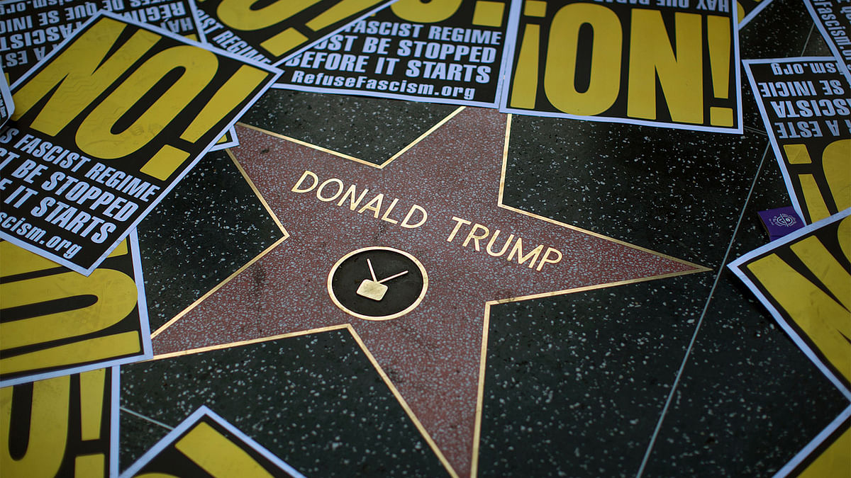 The Hollywood Walk of Fame star for Donald Trump is framed in protest posters during a demonstration in reaction to a Twitter post by US President-elect Trump referring to expansion of the United States nuclear arsenal on 25 December in Los Angeles, California. Photo: AFP