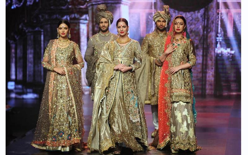 Models present creations by designer Mohsin Naveed Ranjha on the first day of Bridal Couture Week-Gold Edition in Karachi on May 6, 2016. Photo: AFP