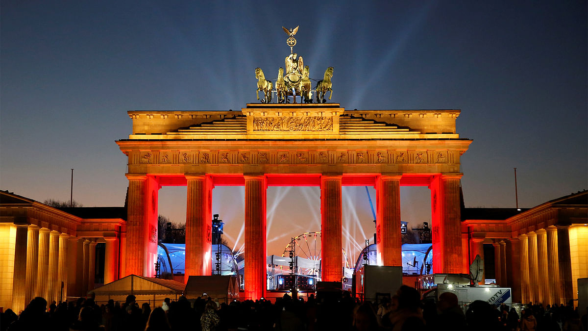 Visitors watch the sound and light check at the Brandenburg Gate, ahead of the upcoming New Year`s Eve celebrations in Berlin, Germany. Photo: Reuters