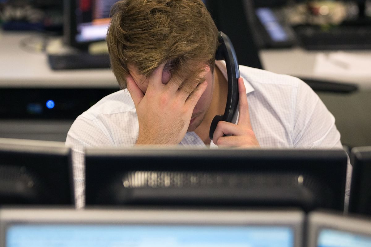 This file photo taken on November 9, 2016 shows a trader from ETX Capital working in central London following the result of the US presidential election. Photo: AFP