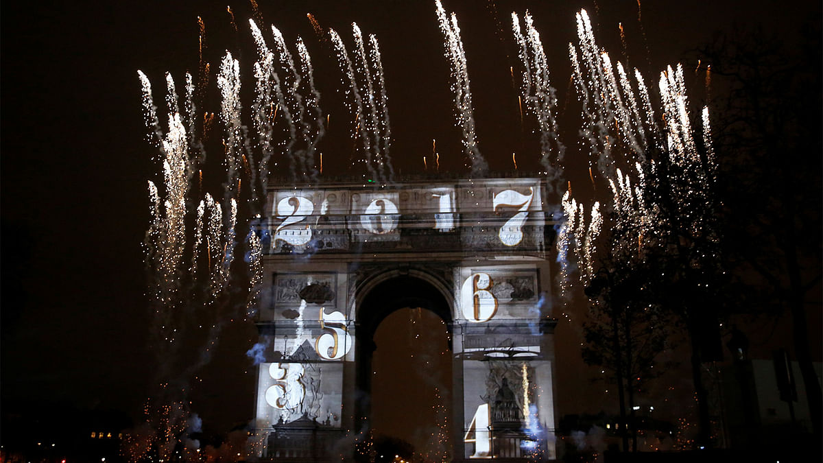 View of a light show on the city`s iconic Arc de Triomphe monument during the New Year celebration in Paris, France, January 1, 2017. Reuters