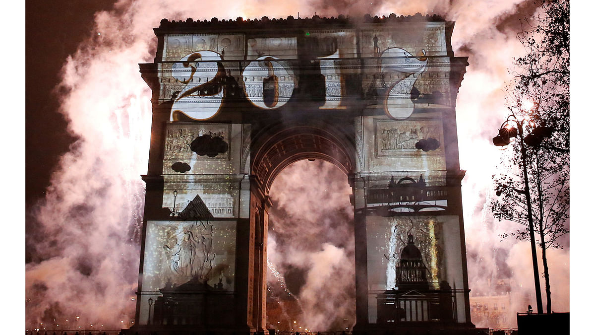 View of a light show on the city`s iconic Arc de Triomphe monument during the New Year celebration in Paris, France, December 31, 2016. Reuters