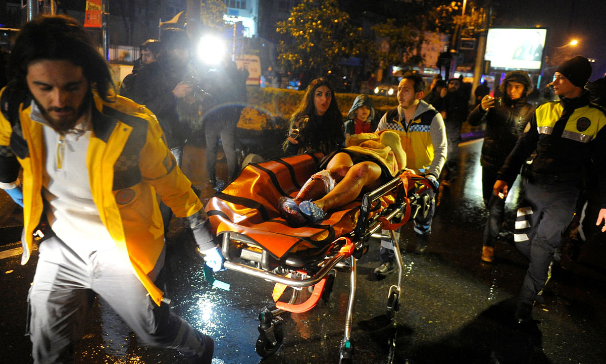 An injured woman is carried to an ambulance from a nightclub where a gun attack took place during a New Year party in Istanbul, Turkey early Sunday. Reuters photo
