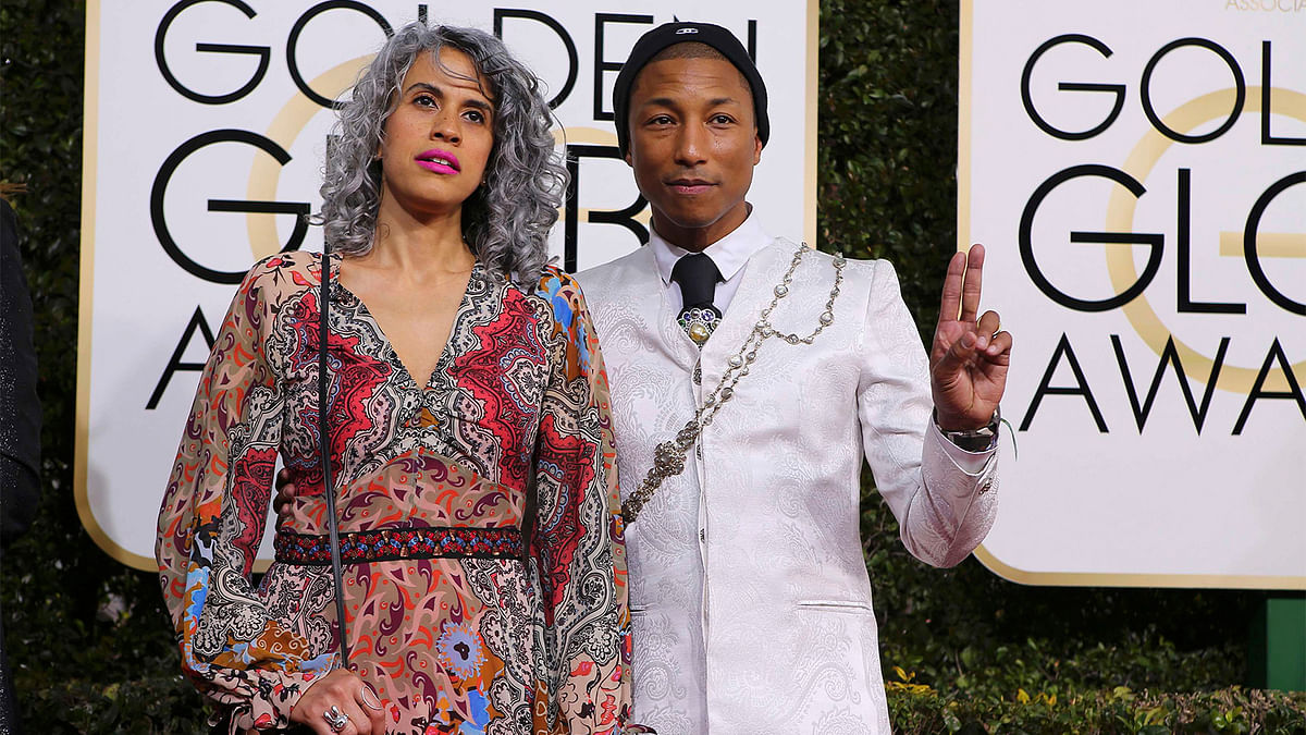 Musician Pharrell Williams and producer Mimi Valdes arrive at the 74th Annual Golden Globe Awards in Beverly Hills, California, U.S., January 8, 2017. Photo: Reuters