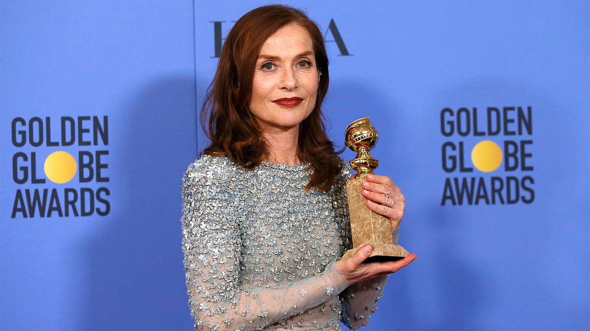 Actress Isabelle Huppert poses backstage with her award for Best Performance by an Actress in a Motion Picture - Drama for her role in `Elle,` at the 74th Annual Golden Globe Awards in Beverly Hills, California, U.S., January 8, 2017. Photo: Reuters