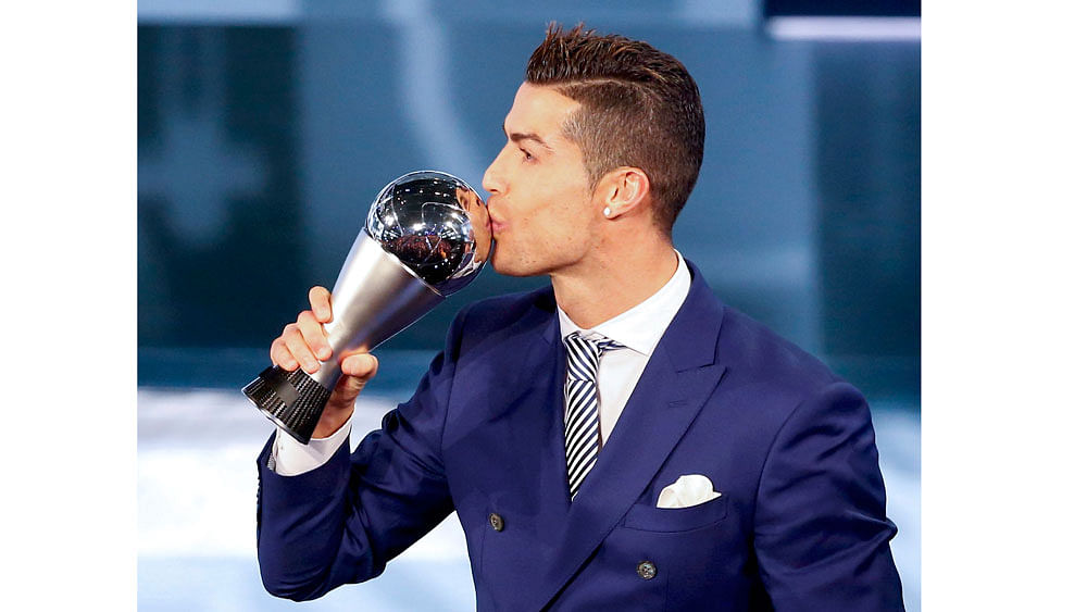 Cristiano Ronaldo celebrates with the trophy. Reuters