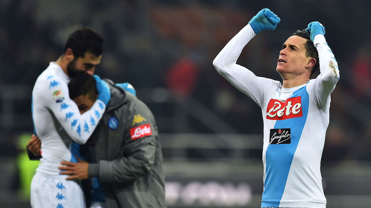 Napoli’s Spainish midfielder Jose Maria Callejon ® celebrates at the end of the Italian Serie A football match between AC Milan and Napoli at the San Siro Stadium in Milan. Photo: AFP