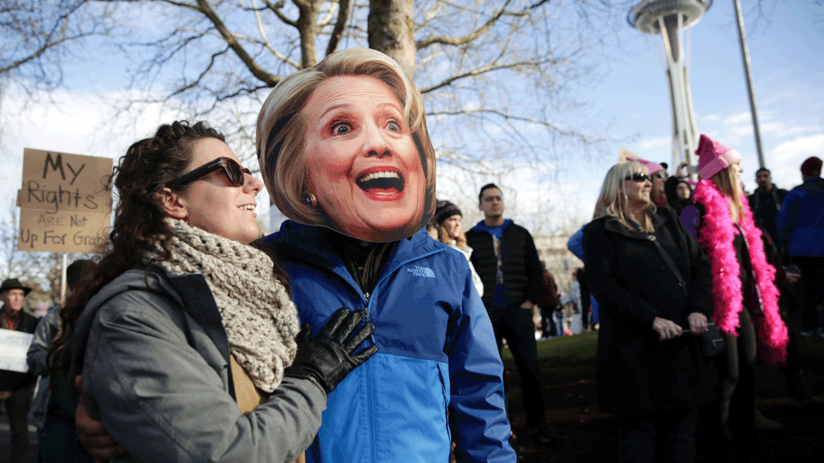 Brittany Martin and her boyfriend Daniel Riojas, pictured in a Hillary Clinton mask, participate in the Women`s March in Seattle, Washington on January 21, 2017. Photo: AFP
