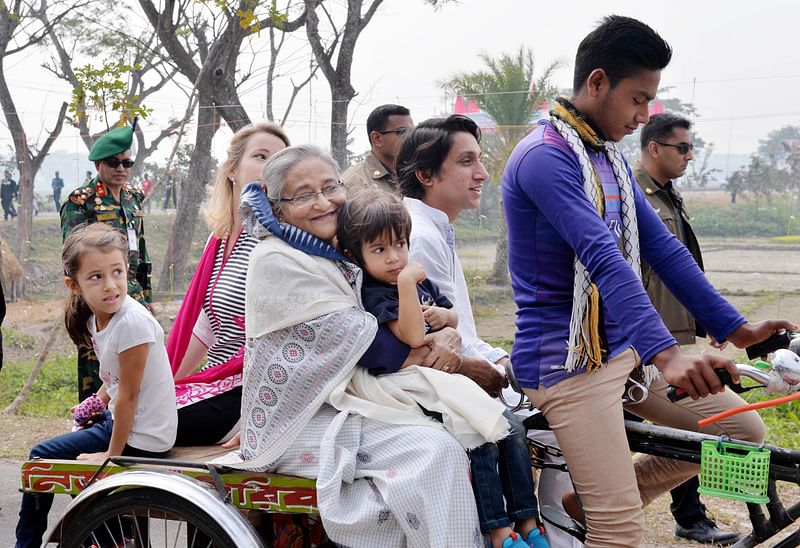 Prime minister Sheikh Hasina visits village on a local rickshaw van. Photo: Focus Bangla