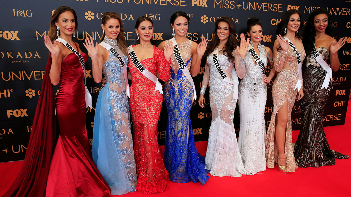 Miss Universe candidates gestures for a picture during a red carpet inside a SMX convention in metro Manila. Reuters