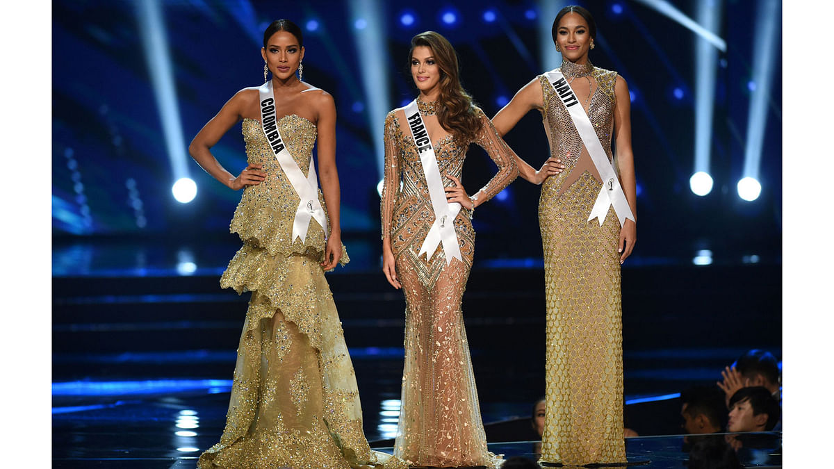 Miss Universe candidates (L to R) Andrea Tovar of Colombia, Iris Mittenaere of France and Raquel Pelissier of Haiti stand on stage as they wait for the announcement of the winner during the finals of the Miss Universe pageant at the Mall of Asia Arena in Manila on January 30, 2017. AFP