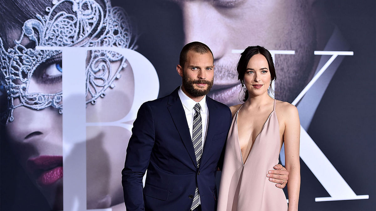 Actors Jamie Dornan and Dakota Johnson attend the premiere of Universal Pictures` `Fifty Shades Darker` at The Theatre at Ace Hotel on February 2, 2017 in Los Angeles, California. Photo: AFP