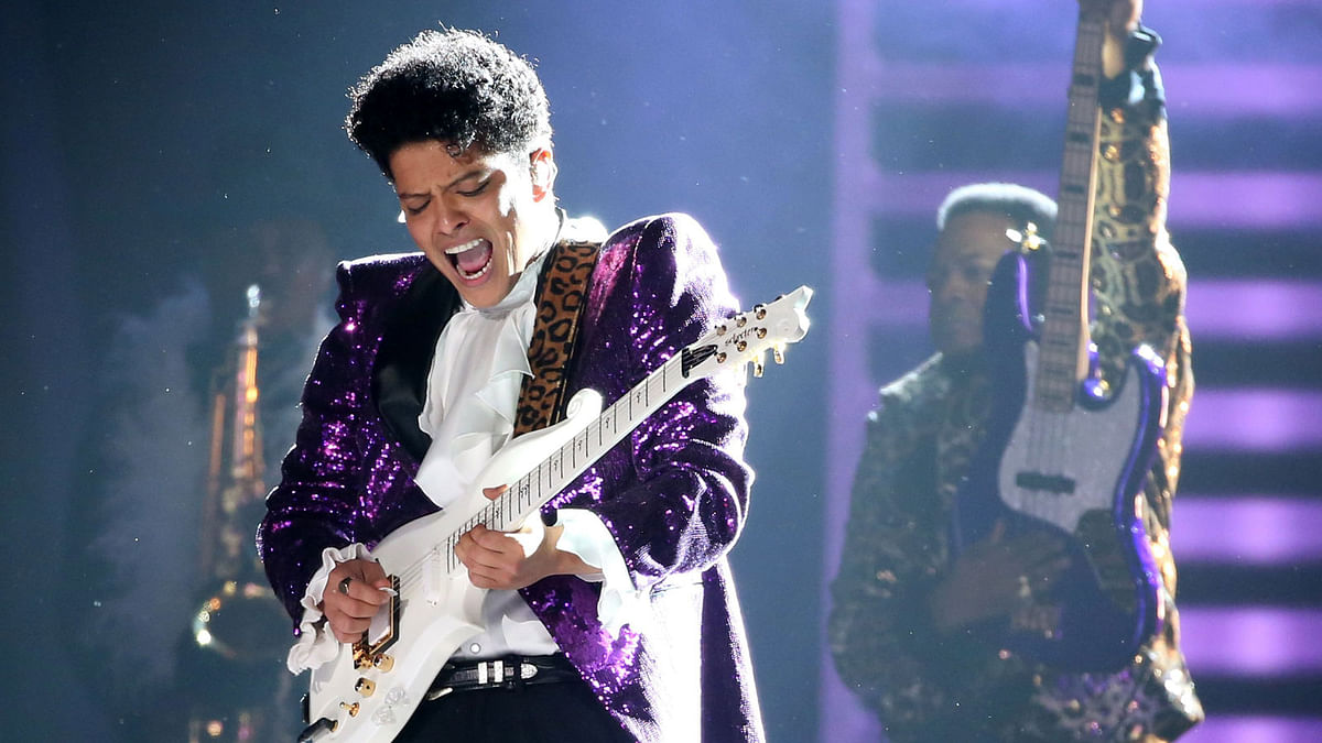 Bruno Mars performs `Let`s Go Crazy` during a tribute to the late singer Prince at the 59th Annual Grammy Awards in Los Angeles. Reuters
