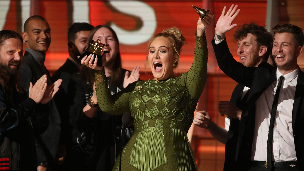 Adele breaks the Grammy for Record of the Year for `Hello` after having it presented to her at the 59th Annual Grammy Awards in Los Angeles. Reuters