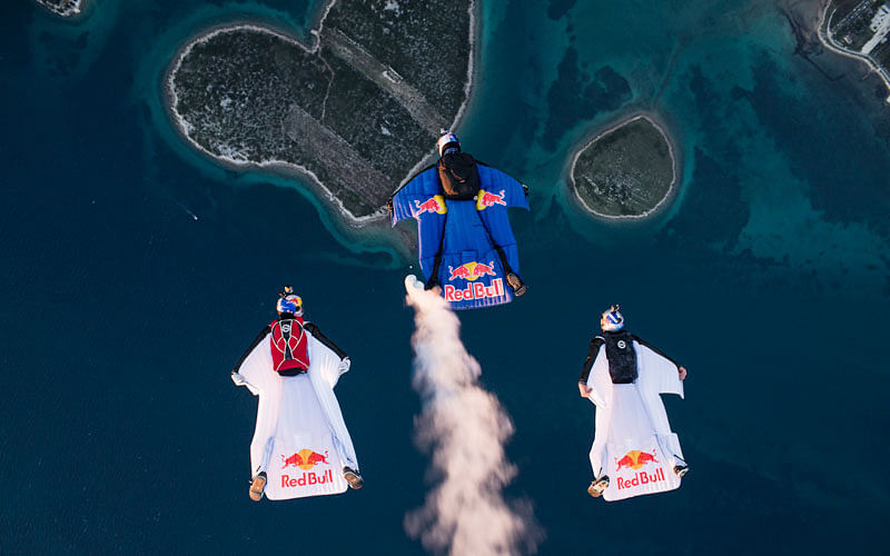 Marco Waltenspiel, Amy Chmelecki and Marco Fuerst fly their wingsuits over the heart island near Zadar, Croatia, November 30, 2016. Photo: Reuters