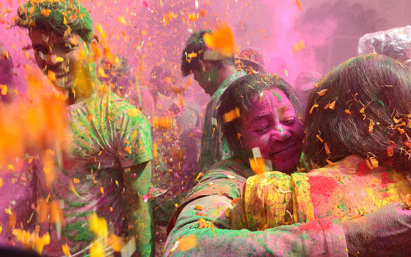 Indian widows celebrate Holi or the `festival of colors` in Vrindavan on March 9, 2017. Widows congregated on a small patio of the Govinath temple in which they live and danced and played with colored powder to celebrate the occasion. Photo: AFP