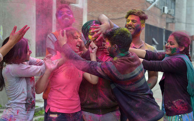 Indian students celebrate the Holi festival with coloured powder at Guru Nanak Dev University in Amritsar on March 10, 2017. Holi, the popular Hindu spring festival of colours, is observed in India at the end of the winter season on the last full moon of the lunar month, and will be celebrated on March 13 this year. Photo: AFP