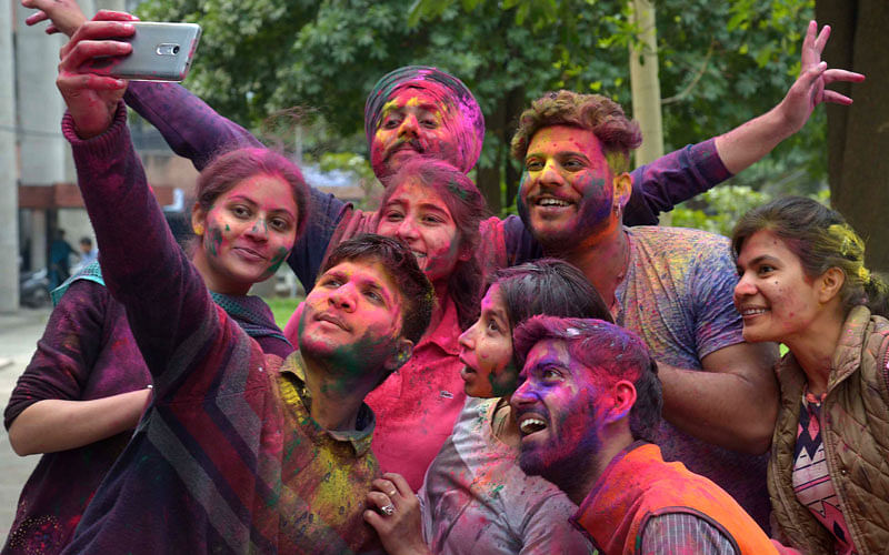 Indian students take a selfie as they celebrate the Holi festival with coloured powder at Guru Nanak Dev University in Amritsar on March 10, 2017. Holi, the popular Hindu spring festival of colours, is observed in India at the end of the winter season on the last full moon of the lunar month, and will be celebrated on March 13 this year. Photo: AFP