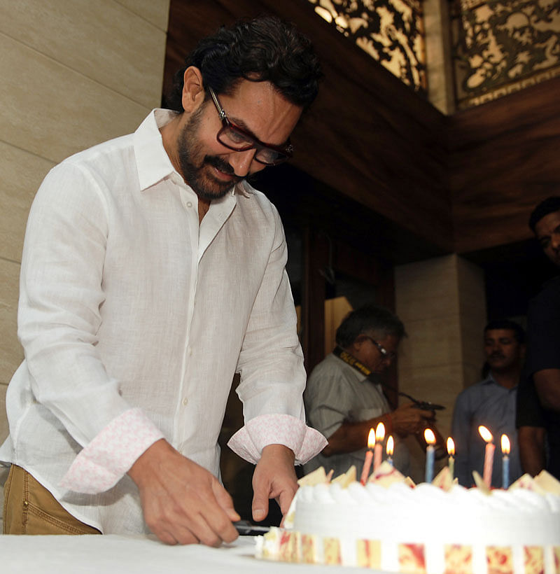 Indian Bollywood actor and producer Aamir Khan poses for the media during the cake cutting on his 52nd birthday, at his residence in Mumbai on March 14, 2017. AFP