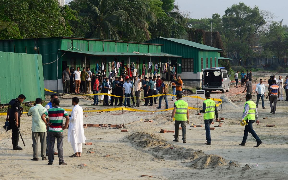 Crime Scene Unit investigating members inspect the spot after a man blew himself up at a camp for Bangladesh's elite security forces in Dhaka on 17 March 17. Photo: AFP