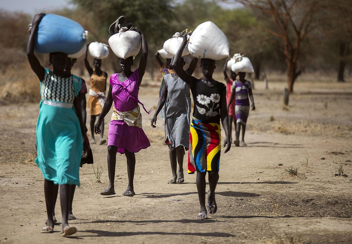 Women carry food in gunny bags after visiting an aid distribution centre in Ngop in South Sudan’s Unity State. Photo: AFP