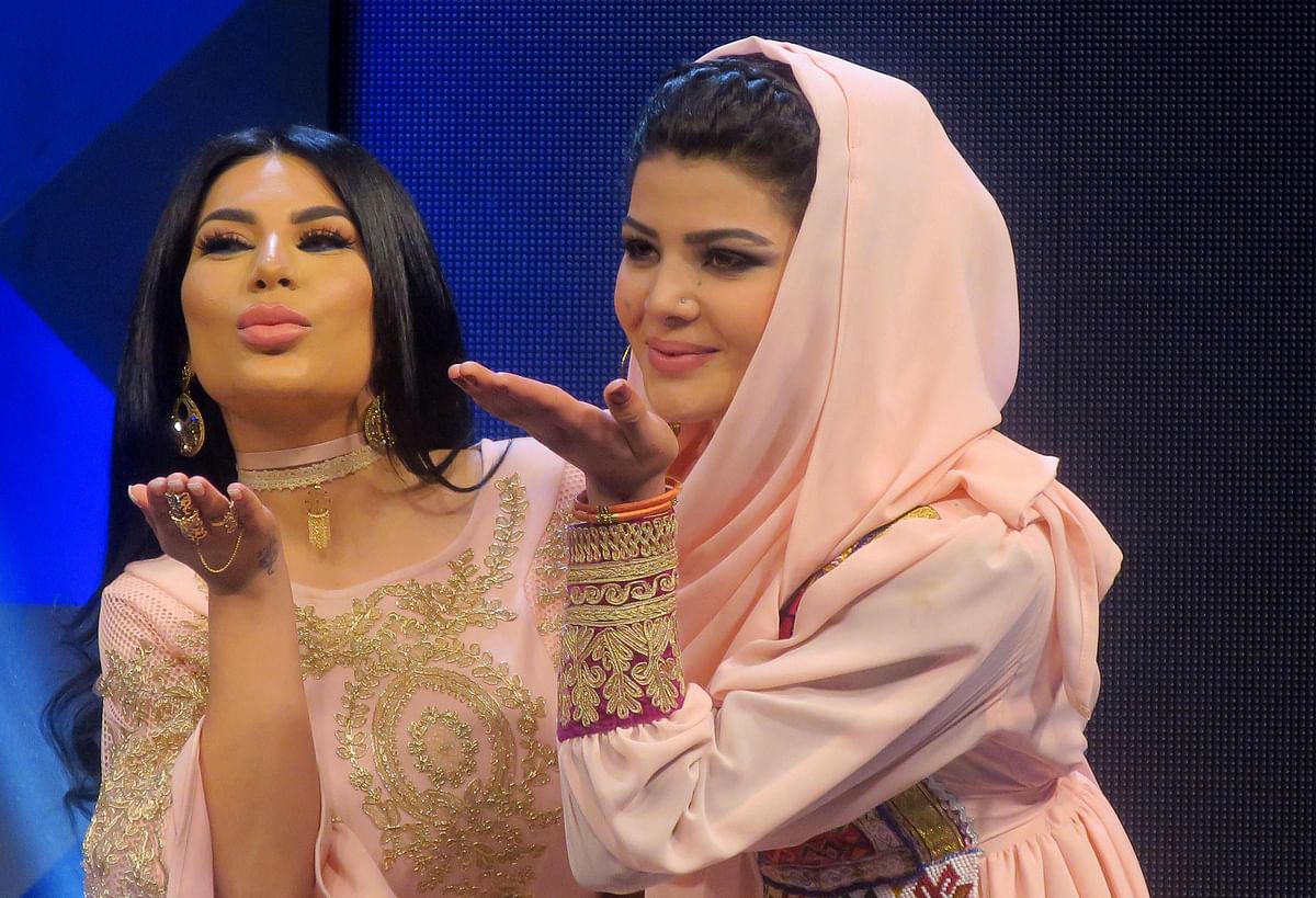 In this photograph taken on 9 March, 2017, Afghan Aryana Sayeed (L) a judge of the television music competition 'Afghan Star' poses with young competitor Zulala Hashemi in Kabul. Photo: AFP
