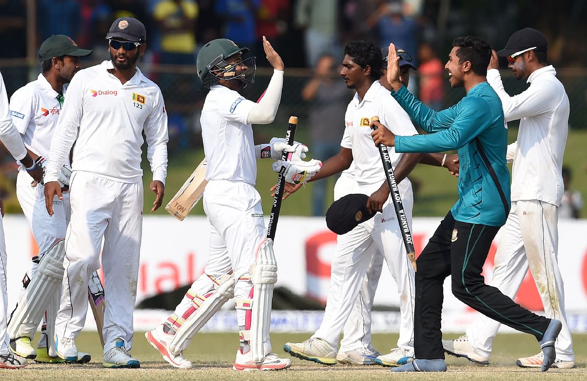 Bangladesh captain Mushfiqur Rahim (C) and teammates celebrate their victory over Sri Lanka by four wickets on the fifth and final day of the second and final Test cricket match between Sri Lanka and Bangladesh at The P Sara Oval Cricket Stadium in Colombo on 19 March, 2017. Photo: AFP