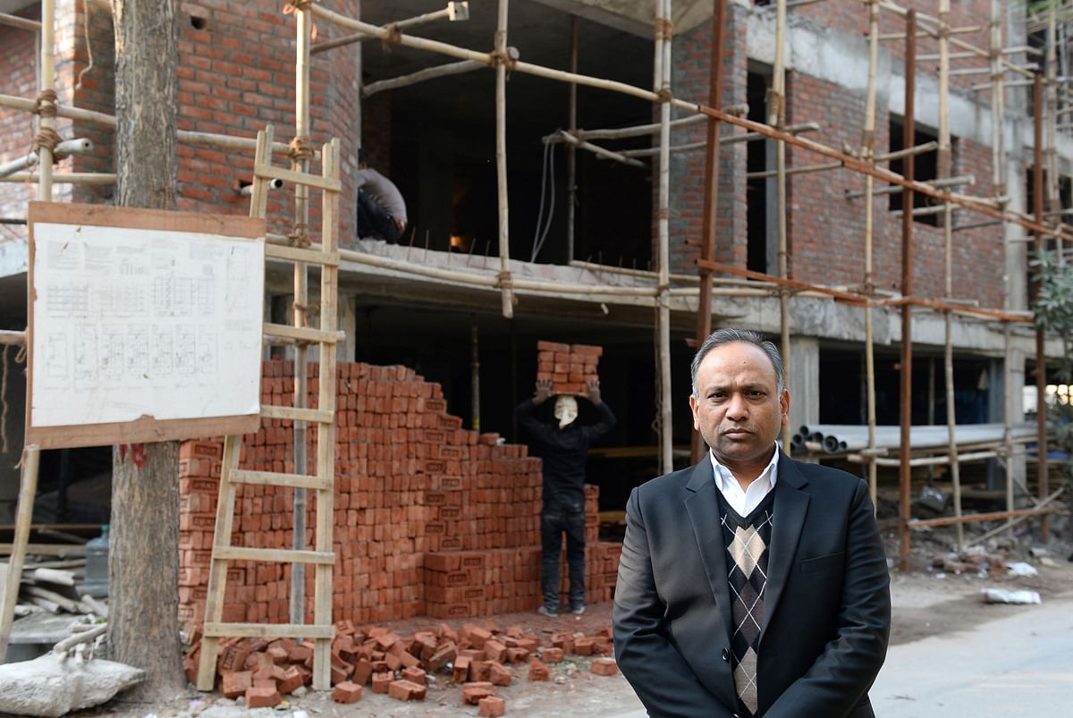 Indian lawyer Naresh Gupta poses outside an under-construction building in New Delhi. AFP file photo