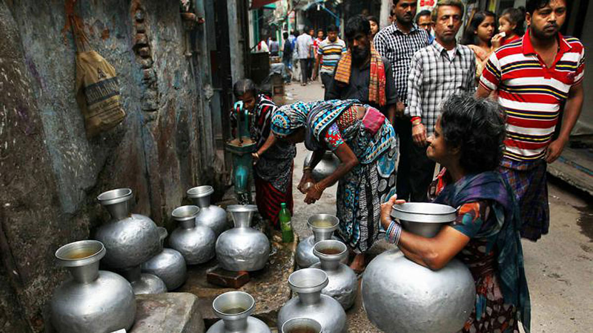 Pitchers are queued up for collecting water from a single source at Tanti Bazar in Dhaka on 21 March. Photo: Sajid Hossain.