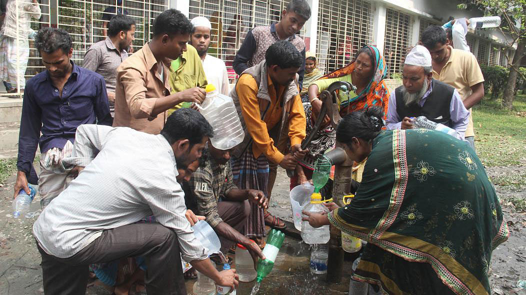 Attendants of patients collect water from one of the two tube wells at Mymensingh Medical College Hospital. The photo was taken on 22 March. Photo: Jaglul Pasha.