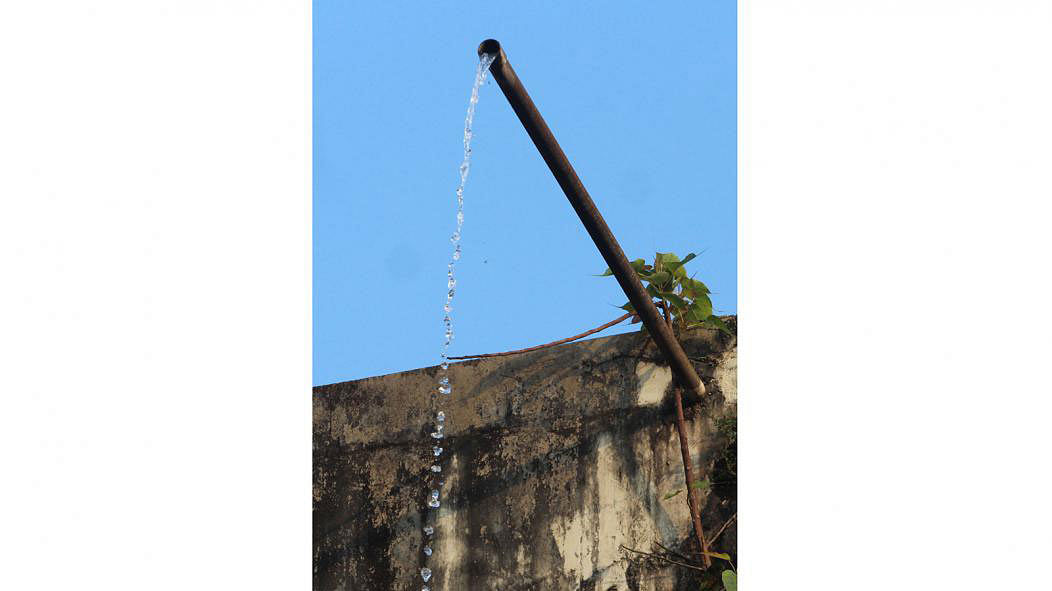 Water falls from a pipe from a water tank. Everyday clean water is wasted all over the world. The photo was taken at Sylhet Police Lines area on 22 March. Photo: Anis Mahmud