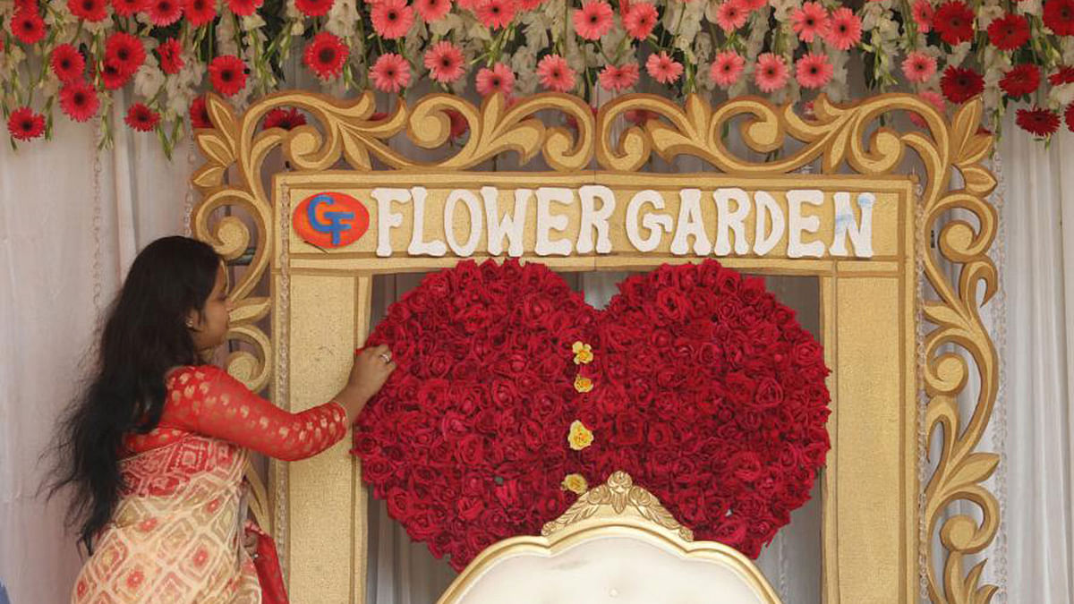 A woman decorates a stall at flower festival at  Bangla Academy. Photo: Abdus Salam