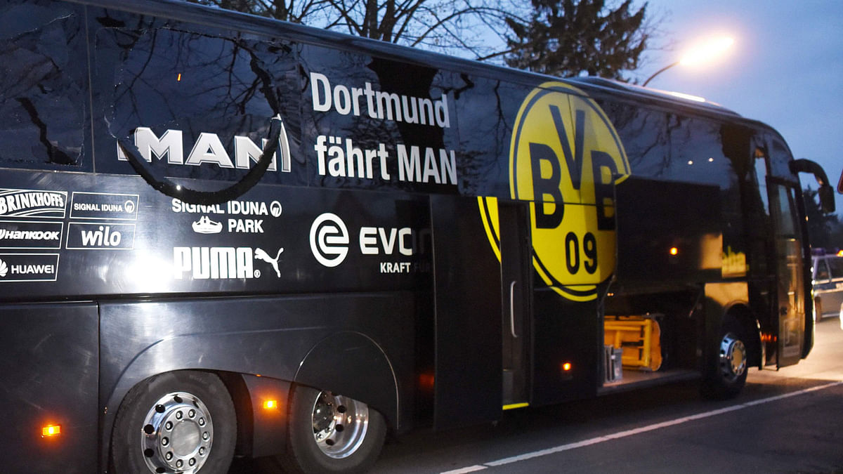 Police forensics officers search the area after an explosion damaged the bus of Borussia Dortmund some 10km away from the stadium prior to the UEFA Champions League 1st leg quarter-final football match BVB Borussia Dortmund v Monaco in Dortmund, western Germany. Photo: AFP