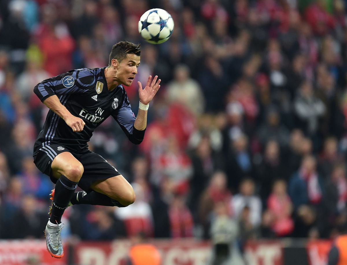 Real Madrid's Portuguese striker Cristiano Ronaldo heads the ball during the UEFA Champions League 1st leg quarter-final football match FC Bayern Munich v RealMadrid in Munich, southen Germany on April 12, 2017.  AFP