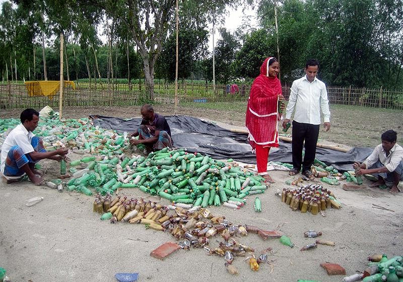 Collected bottles being sorted for the construction of the house. Photo: Prothom Alo