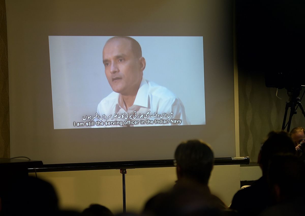 This file photo taken on 29 March, 2016 shows Pakistani journalists watching a video showing Indian national Kulbhushan Yadav, arrested on suspicion of spying, during a press conference in Islamabad. India on 15 May, 2017 appealed to the UN's top court to order Pakistan to suspend its planned execution of an Indian national convicted of spying. Photo: AFP