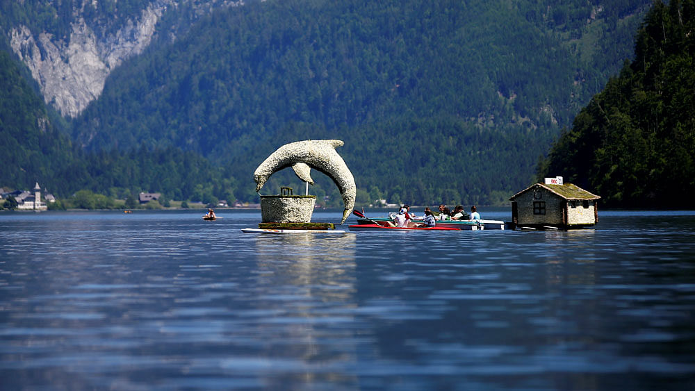 A float, decorated with a figure made of daffodil blossoms, participates in a parade during the daffodil festival (Narzissenfest) on Grundlsee lake in Grundlsee, Austria, May 28, 2017. Reuters