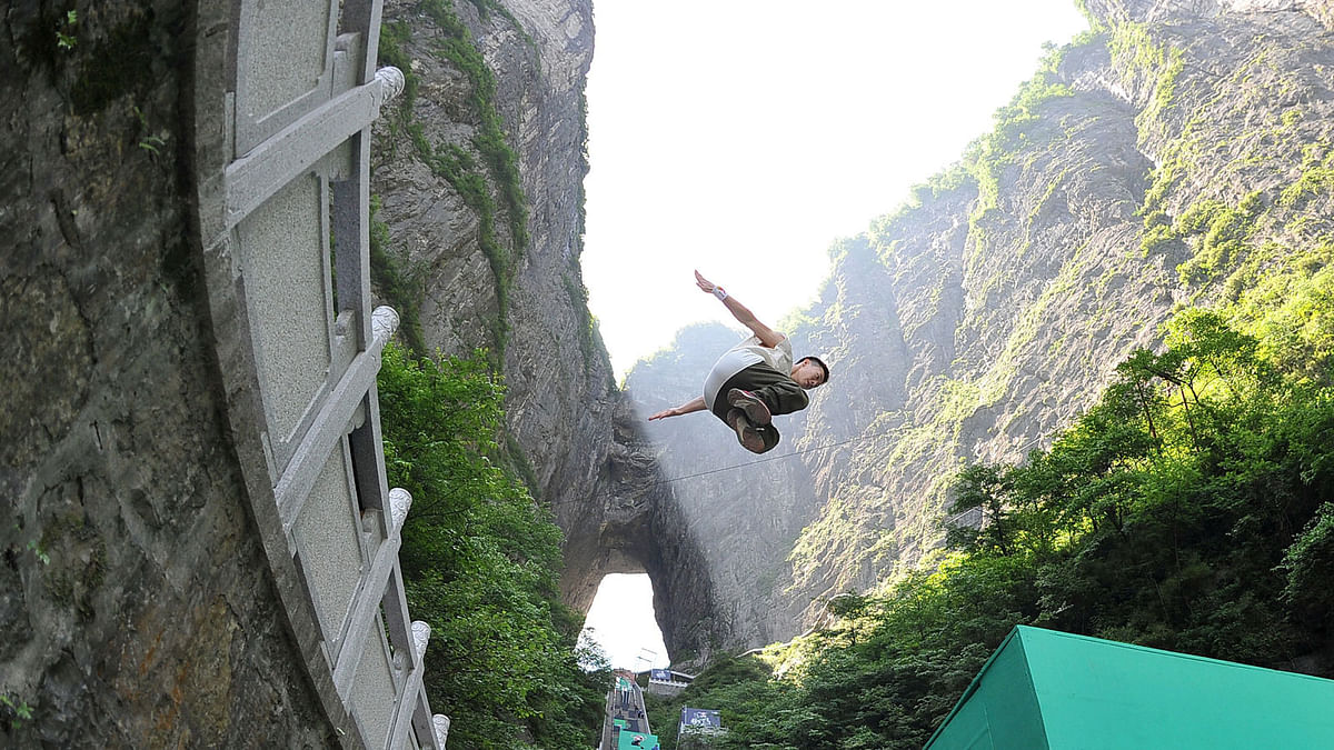 A contestant takes part in a parkour competition at Tianmen mountain, in Zhangjiajie, Hunan province, China May 26, 2017. Reuters
